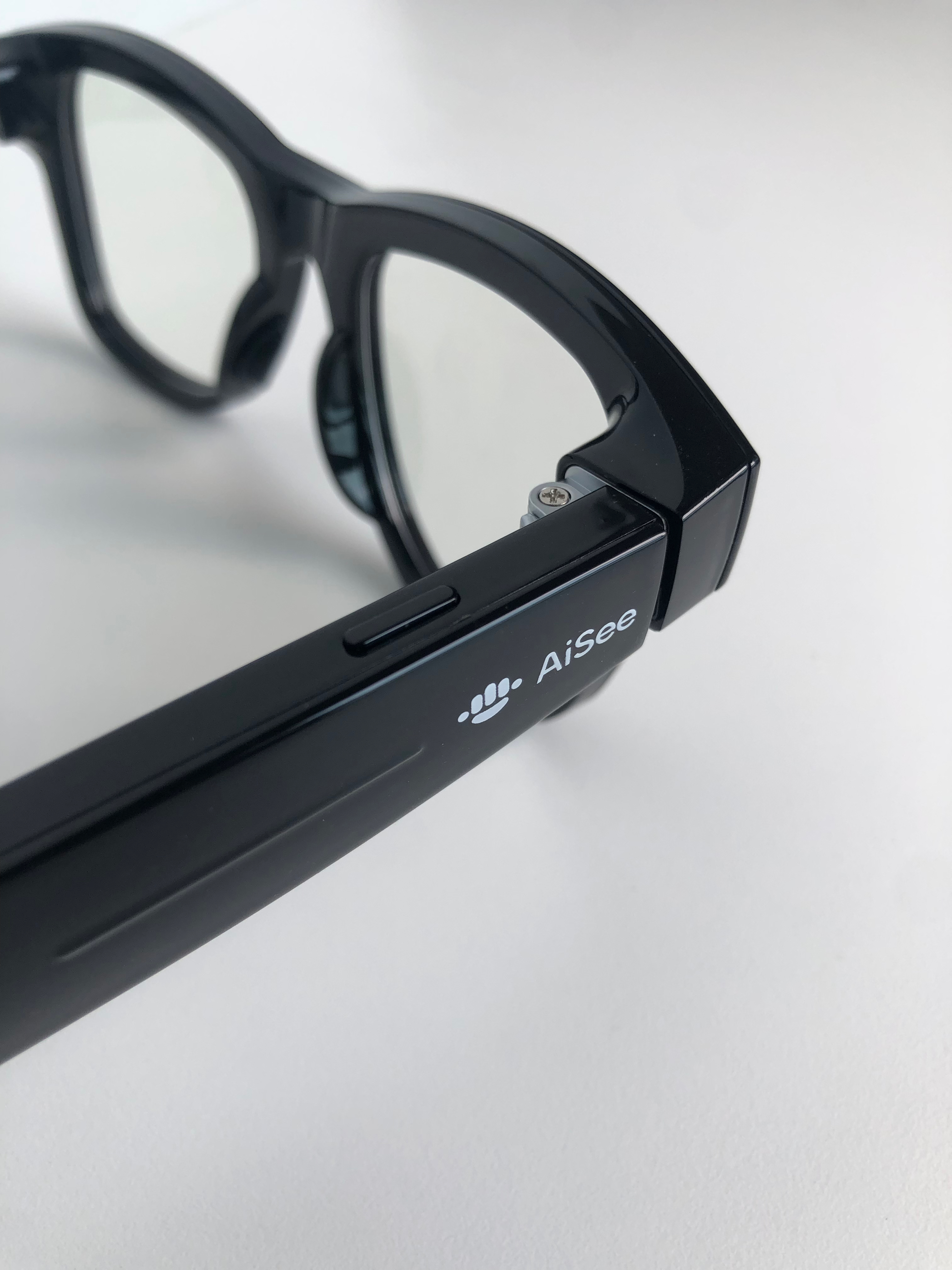 Close up of glasses showing a button and touch bar on the right arm.